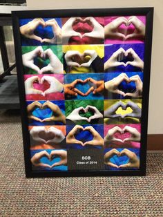 a multicolored photo frame with hands in the shape of heart on top of each other