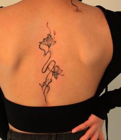 the back of a woman's shoulder with flowers on it