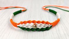 an orange, white and green beaded headband