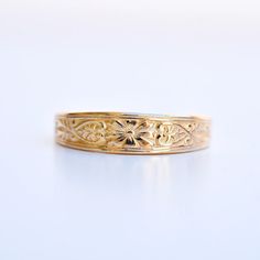 An antique mold was utilized in this faithful reproduction wedding band. Motif is a stylized daisy center flanked by tiny hearts and vines.  Other information: Recycled 14 karat yellow gold Finger size US 7 1/4* Made from vintage methods and instruments in recycled gold by Hugo Kohl and team in his Harrisonburg, VA st Enamel Wedding Band, Art Deco Engraved Yellow Gold Ring For Wedding, Floral Engraved Wedding Band, Victorian Engraved Yellow Gold Ring, Art Nouveau Style Gold Engraved Rings, Art Nouveau Wedding Band, Art Nouveau Engraved Yellow Gold Ring, Art Nouveau Yellow Gold Ring, Belle Epoch