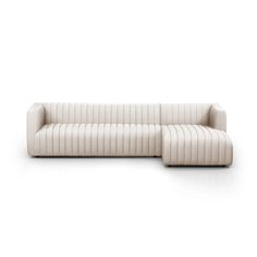 a white couch sitting on top of a white floor