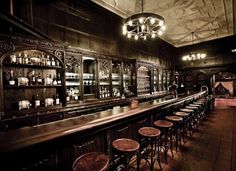 an old fashioned bar with lots of stools