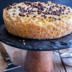 a cake with chocolate chips on top sitting on a table