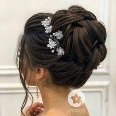 a woman wearing a hair comb with flowers on it