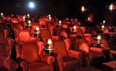 an empty theater with rows of chairs and candles