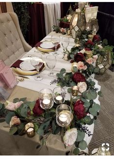 the table is set with candles, plates and napkins for an elegant dinner party