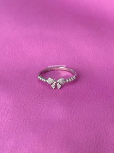 A stunning ring featuring a ribbon bow tie with sparkly cubic zirconia stones. - Water resistant - 925 sterling silver - Will not rust or tarnish - Select desired size at checkout Bow Tie Ring, Ribbon Bow Tie, Cute Promise Rings, Tie Ring, Preppy Jewelry, Present Birthday, Silver Ribbon, Bow Ring, Jewelry Accessories Ideas