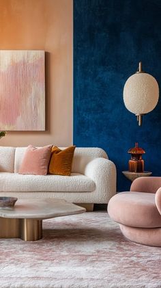 a living room with pink and blue walls, white furniture and rugs on the floor