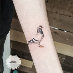 a small bird tattoo on the wrist