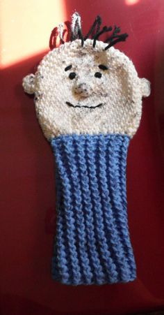 a knitted object with a smiling face on it