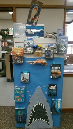 a book display with books on it and a shark's mouth