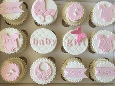 baby shower cupcakes in a box with pink and white icing on them