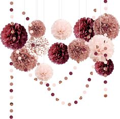 pink and burgundy flowers hanging from strings with confetti