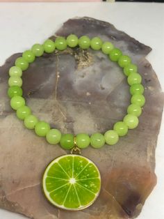 This zesty looking, beautiful lime  stretch bracelet is made with gorgeous lime colored, 6 mm dyed jade round beads & is finished with a realistic looking gold plated enamel lime  pendant charm. It's so bright and beautiful and perfect for the summer.  7 inches in length on 100% polyester stretch cord, not wire. Lime Green Bracelet, Fruit Bracelet, Bracelet Summer, Summer Bracelet, Green Bracelet, Fruit Jewelry, Jewelry Summer, Summer Bracelets, Mothers Necklace