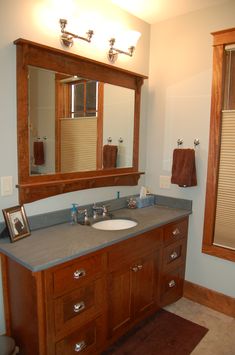 a bathroom with two sinks and mirrors in it