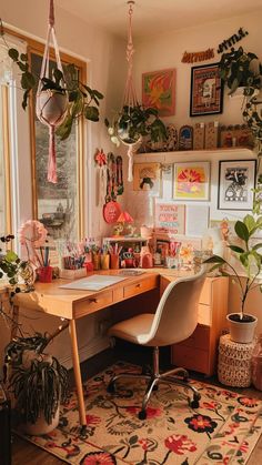 a home office with lots of plants on the desk and hanging potted houseplants