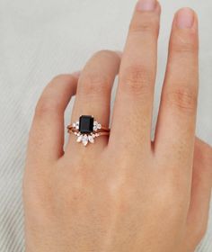 a woman's hand with a black and white diamond ring