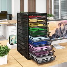 a computer desk with a stack of files in front of it and a monitor on the other side