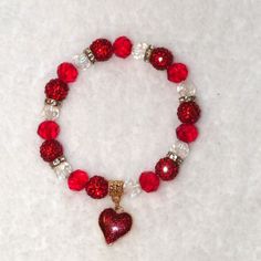 ~Pretty Heart Charm Beaded Stretch Bracelet ~Round Crystal & Red Faceted Glass Beads With Round Red Crystal Rhinestone Beads ~Accented With Gold Metal & Crystal Rhinestone Rondelle Spacers ~Decorative Gold Charm Bale With 5/8" Sparkling Red Glitter Heart Charm ~Perfect For Valentine's Day, Wedding Or Special Occasion ~General Cleaning Instructions: Wipe With A Damp Cloth, Dry With A Soft Cloth. Do Not Immerse In Water Or Jewelry Cleaner. ~Thank You For Your Interest In This Item! ~Please Shop Al Heart-shaped Red Bracelets For Party, Red Heart-shaped Bracelets For Valentine's Day, Red Heart Bracelet For Party, Red Heart Bracelets For Party, Red Heart-shaped Party Bracelets, Red Heart Beads Bracelet For Valentine's Day, Red Beaded Heart Bracelet For Valentine's Day, Adjustable Red Heart Bracelet For Party, Red Beaded Bracelets For Valentine's Day