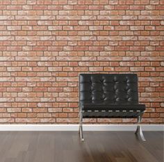 a black leather chair against a brick wall