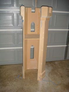 a tall wooden shelf sitting in front of a garage door