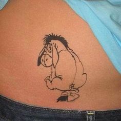 a person with a cartoon tattoo on their back shoulder and the image of winnie the pooh