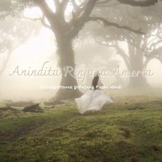 a woman in a white dress is walking through the fog