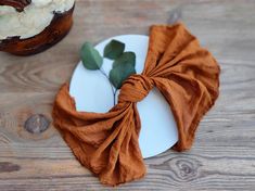 a white plate topped with an orange napkin