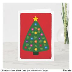 a card with a christmas tree on the front, and an ornament in the back