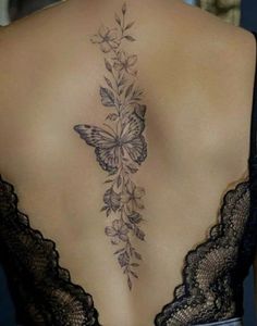 a woman with a butterfly tattoo on her back