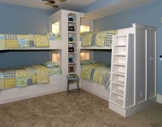 two bunk beds in a room with carpeted flooring and blue walls, one is built into the wall