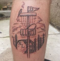 a man's leg with a tattoo on it that has a boat in the water