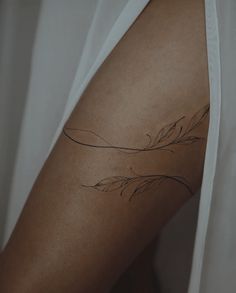 a close up of a person's arm with a tattoo on the left side