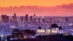 the city skyline is lit up at night