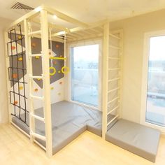 an empty room with bunk beds and windows