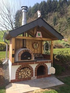 an outdoor pizza oven in the middle of a yard