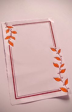 a piece of paper with orange leaves on it