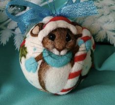 a stuffed animal ornament hanging from a christmas tree