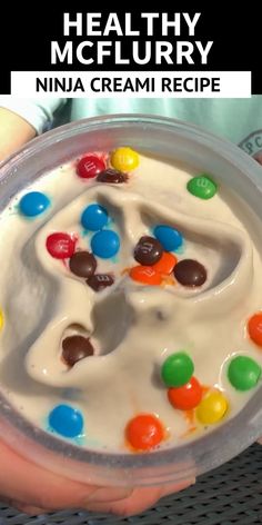 a person holding a bowl filled with ice cream and candy