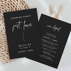 two black and white wedding cards with the words just love written on them next to a wicker basket