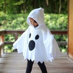 a young child dressed in a ghost costume