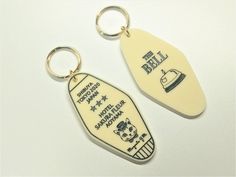 two key chains that are shaped like surfboards