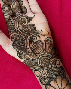 a woman's hand is decorated with hennap and intricate designs on it