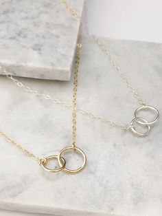 "This interlocking ring necklace also known as infinity necklace or double ring necklace is the perfect everyday necklace or to gift to a loved one. Great way to show never ending love , friendship, or relationship. Model is wearing 16\" in 14k gold filled Model is wearing 17\" in sterling silver Rings measure approximately 8mm & 10mm One ring is slightly smaller then the other All orders come packaged ready for gifting! Order also comes with a, Jewelry Care Instruction Card MADE TO ORDER Ha Minimalist Sterling Silver Jewelry For Friendship, Everyday Nickel-free Infinity Jewelry, Nickel-free Minimalist Friendship Necklaces, Nickel-free Minimalist Necklace For Friendship, Elegant Necklaces For Friendship, Elegant Necklace For Friendship, Minimalist Infinity Jewelry For Friendship, Everyday Infinity Necklace With Adjustable Chain, Adjustable Minimalist Infinity Necklace