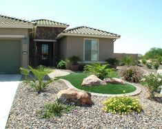 a house with rocks and plants in front of it