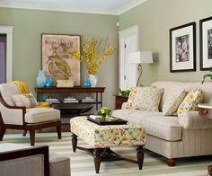 a living room filled with lots of furniture and pictures on the wall above it's coffee table