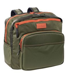 a green backpack with an orange zipper