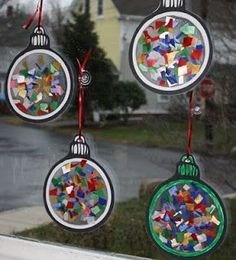 three christmas ornaments hanging from a window