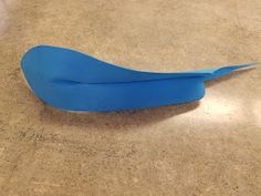 a blue bird shaped object sitting on top of a counter