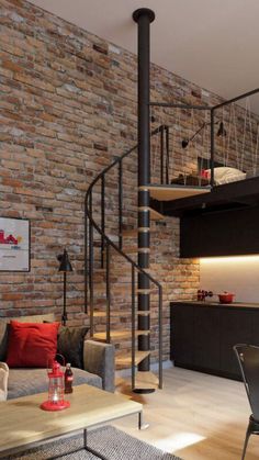 a living room filled with furniture and a spiral staircase in front of a brick wall